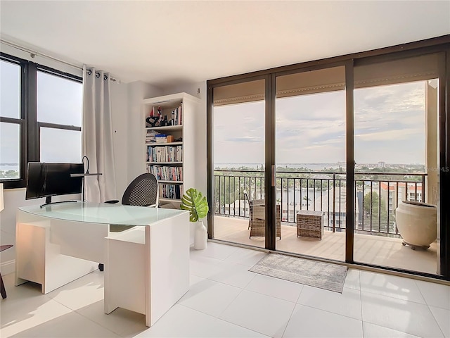 tiled home office featuring floor to ceiling windows