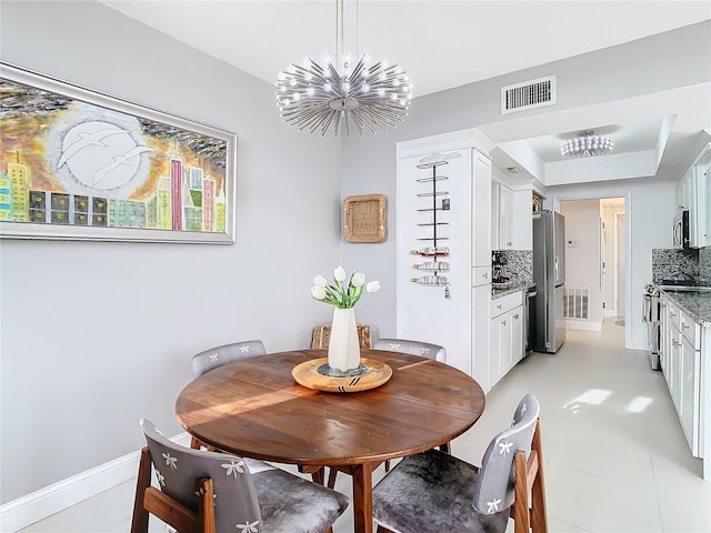 dining room with a notable chandelier and light tile patterned floors