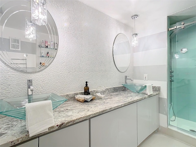 bathroom featuring vanity and a shower with shower door