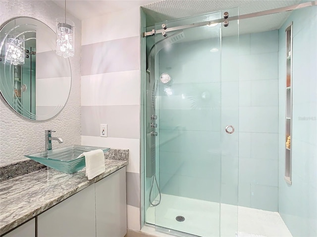 bathroom with walk in shower and vanity