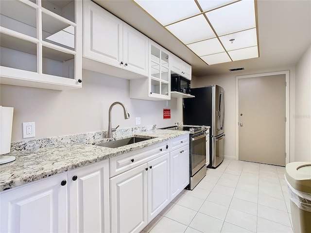 kitchen featuring white cabinetry, appliances with stainless steel finishes, sink, and light tile patterned floors