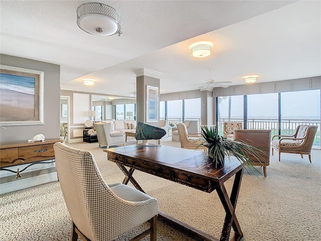 dining area featuring carpet floors, a water view, and ceiling fan