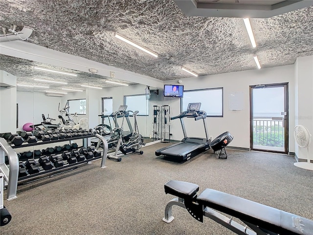 exercise room featuring an AC wall unit