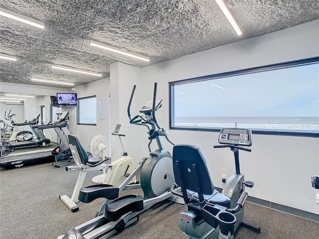 gym featuring a textured ceiling