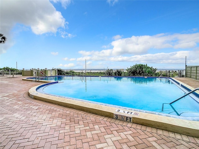 view of swimming pool with a patio area