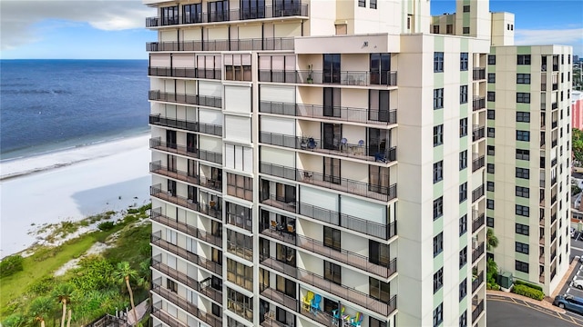 view of property featuring a beach view and a water view