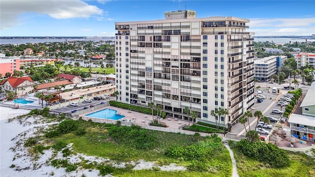 view of property with a water view and a community pool