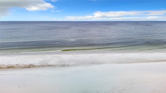 drone / aerial view featuring a water view and a view of the beach