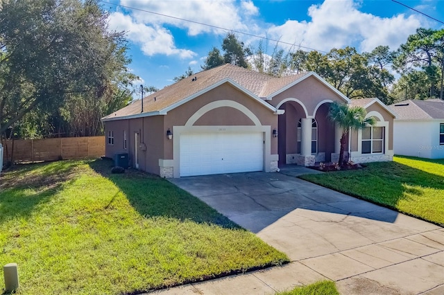 ranch-style house with a garage, central air condition unit, and a front lawn