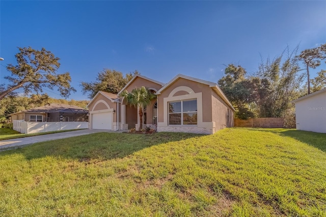 view of front of property with a garage and a front lawn