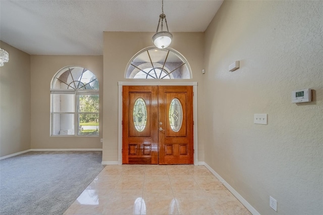 tiled entryway with a textured ceiling