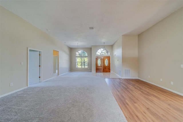 interior space featuring a textured ceiling and light hardwood / wood-style flooring