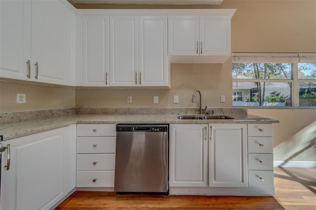 kitchen with white cabinetry, dishwasher, light hardwood / wood-style floors, and sink