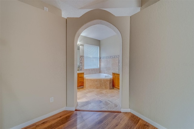 corridor with light hardwood / wood-style floors