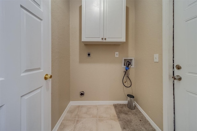 washroom featuring cabinets, washer hookup, light tile patterned floors, and hookup for an electric dryer