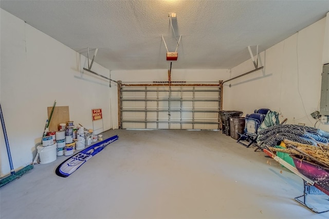 garage with electric panel and a garage door opener