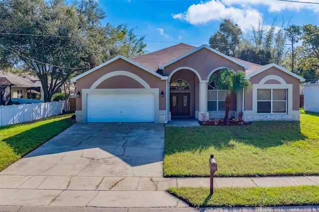 ranch-style home featuring a garage and a front yard