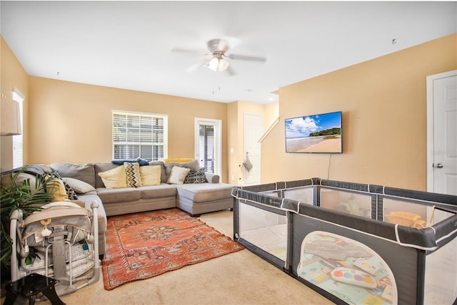 carpeted living room featuring ceiling fan