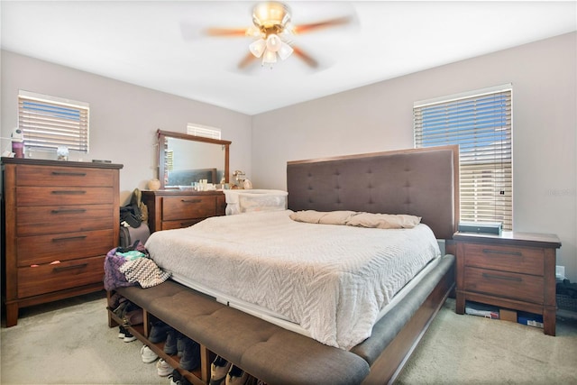 bedroom featuring ceiling fan and light carpet