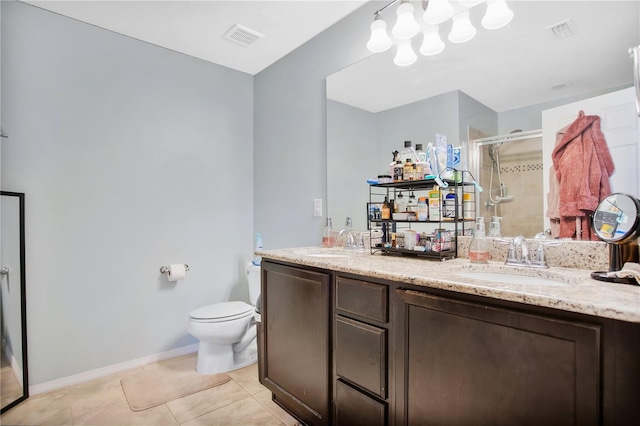 bathroom featuring vanity, toilet, tile patterned floors, and an enclosed shower