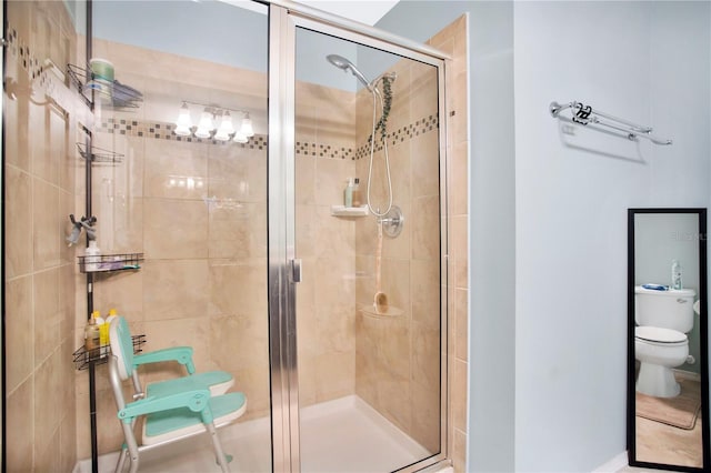 bathroom featuring toilet and an enclosed shower