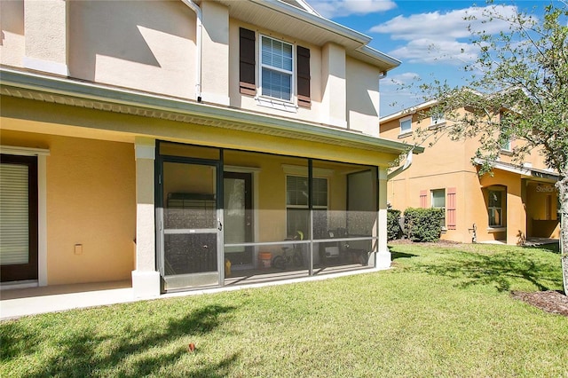 rear view of property featuring a yard