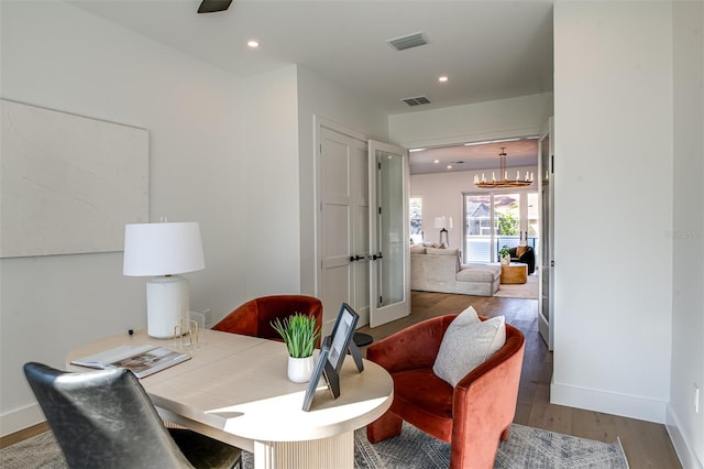 office area with a chandelier and dark wood-type flooring