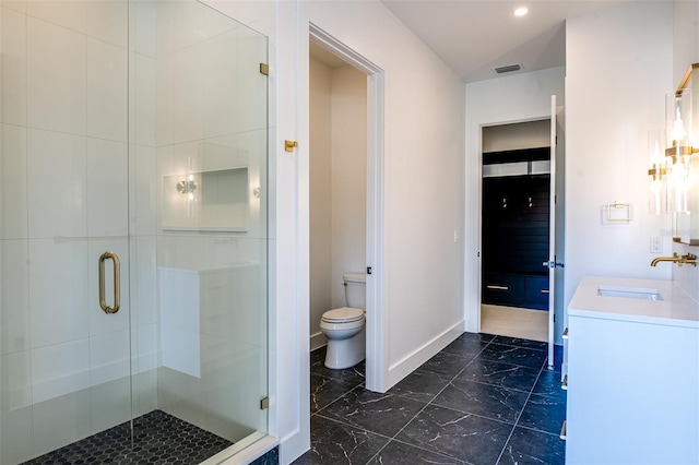 bathroom with vanity, an enclosed shower, and toilet