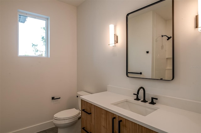 bathroom with a shower, vanity, and toilet