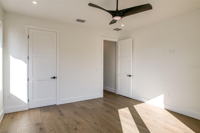 unfurnished bedroom featuring ceiling fan and dark hardwood / wood-style floors