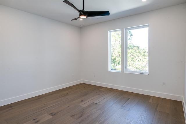 spare room featuring dark hardwood / wood-style flooring and ceiling fan