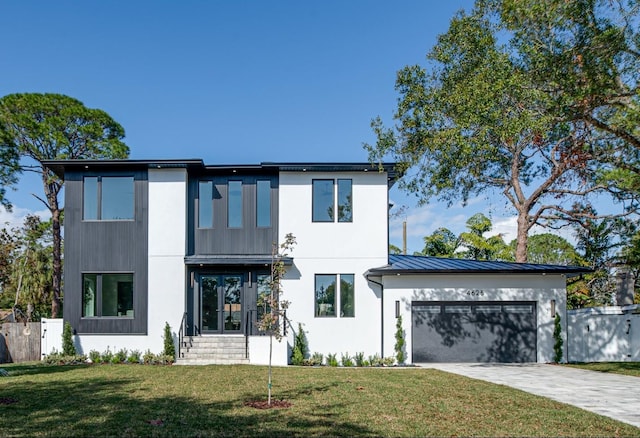 contemporary house with a garage, a front yard, and french doors