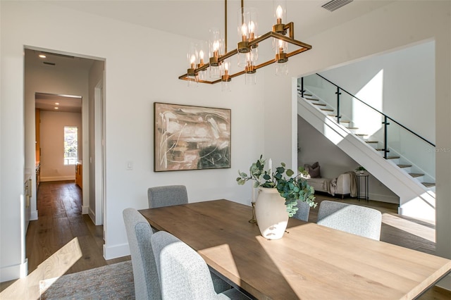 dining area featuring a chandelier and dark hardwood / wood-style floors