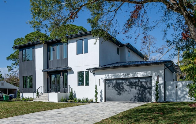 contemporary house with a garage and a front lawn