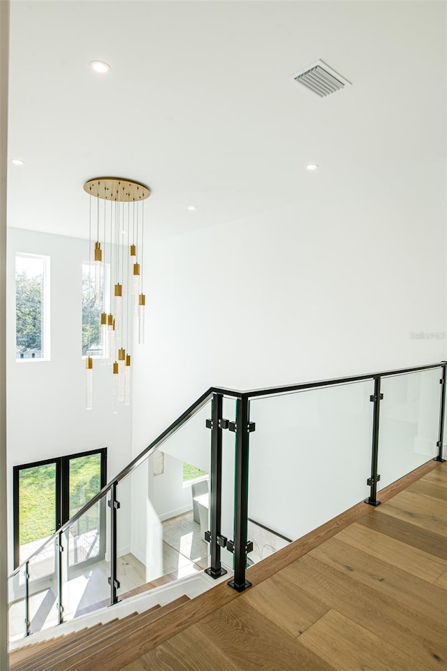 staircase with hardwood / wood-style flooring