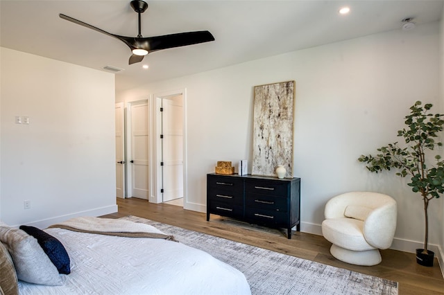 bedroom with hardwood / wood-style floors and ceiling fan