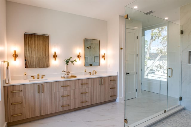 bathroom with vanity and a shower with shower door