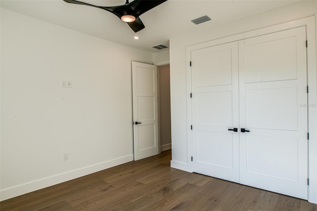 unfurnished bedroom featuring a closet, ceiling fan, and dark hardwood / wood-style floors