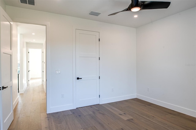 unfurnished bedroom with ceiling fan and light hardwood / wood-style flooring