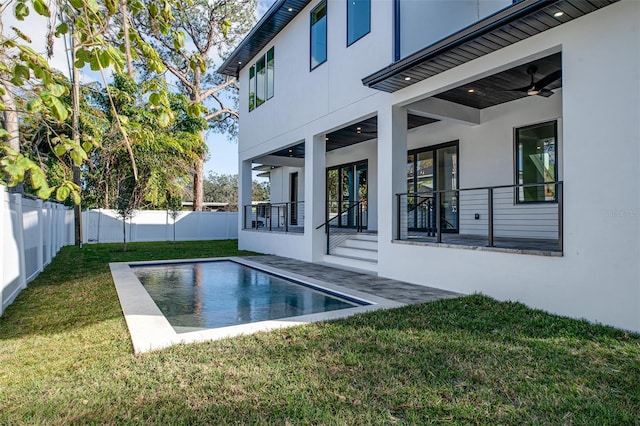 view of pool featuring a lawn, ceiling fan, and a patio