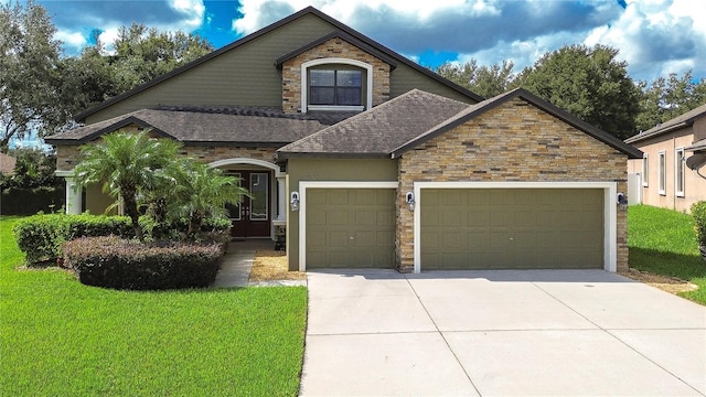 view of front of house with a front yard and a garage