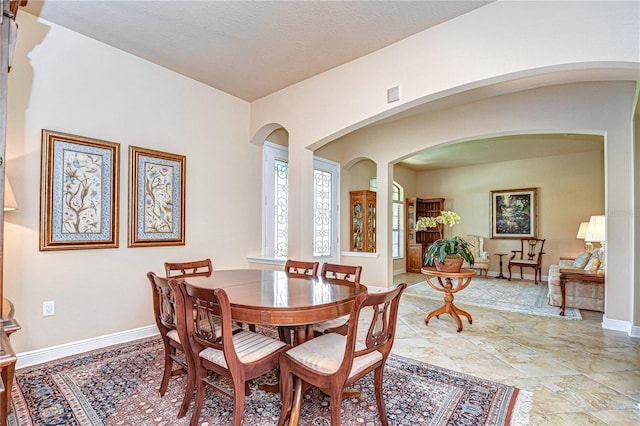 dining room with a textured ceiling