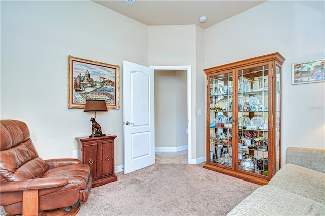 sitting room featuring light carpet