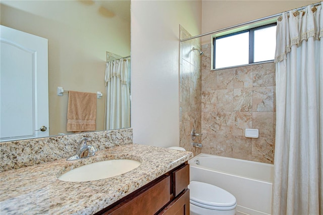 full bathroom with shower / bath combination with curtain, vanity, and toilet