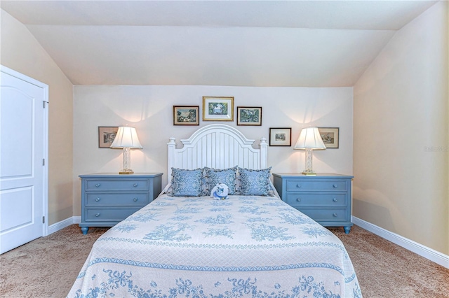 carpeted bedroom featuring lofted ceiling