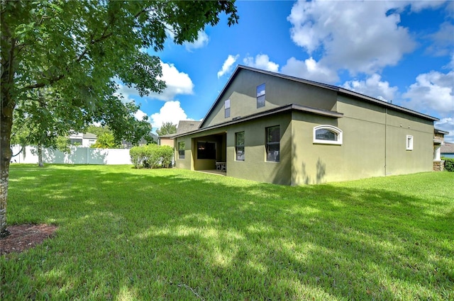 back of house with a yard