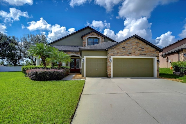 view of front of property featuring a front lawn and a garage