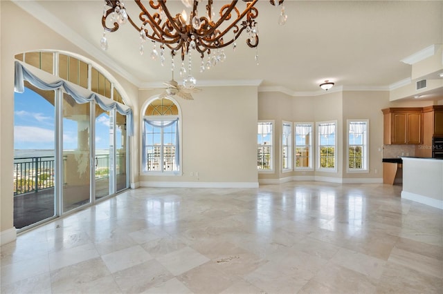 unfurnished living room featuring an inviting chandelier, a healthy amount of sunlight, and crown molding