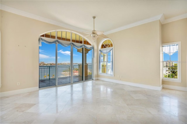 empty room with ceiling fan and ornamental molding