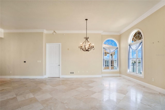 spare room featuring ornamental molding and an inviting chandelier